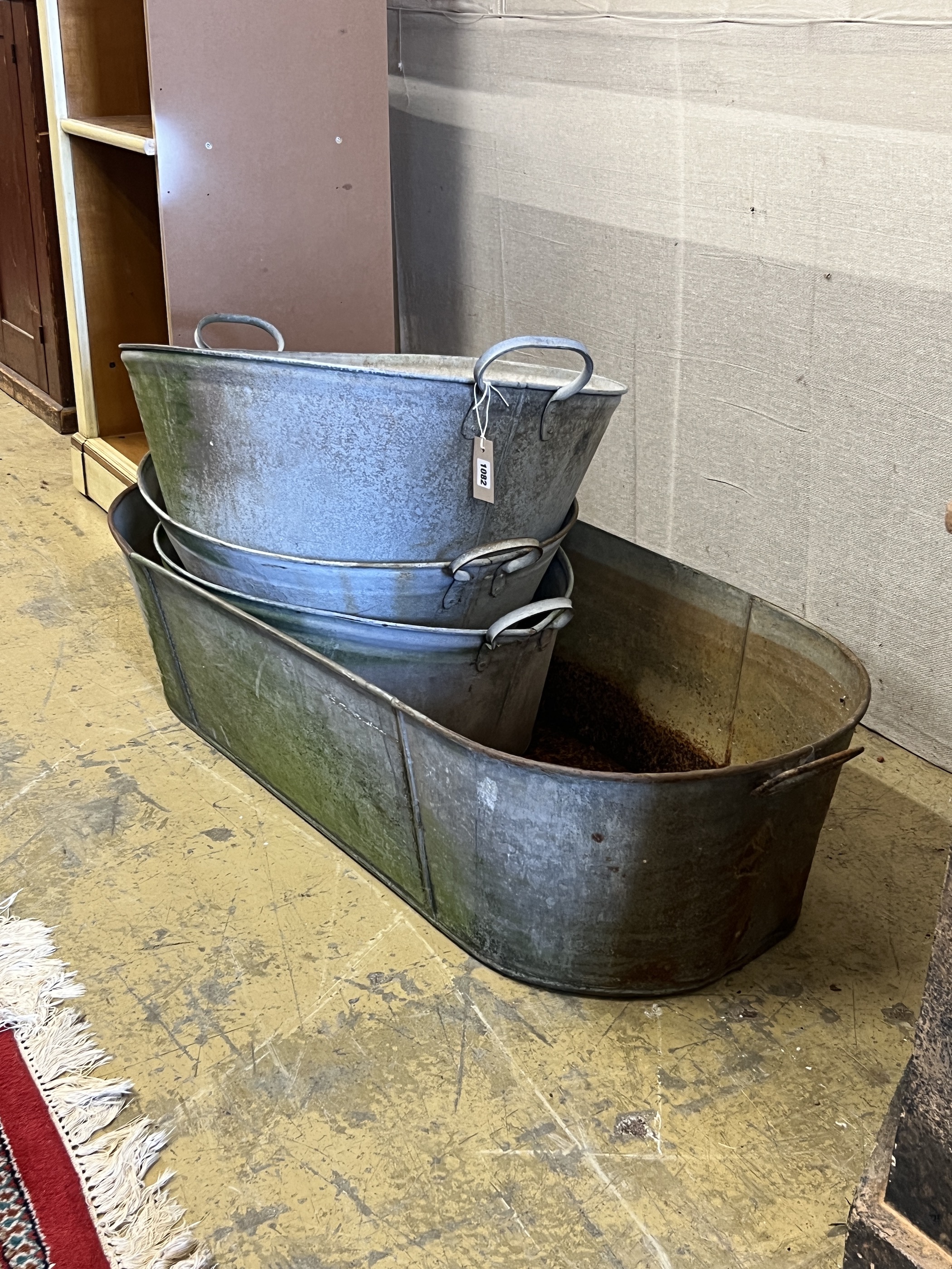 Four vintage galvanised containers, largest width 120cm, height 28cm